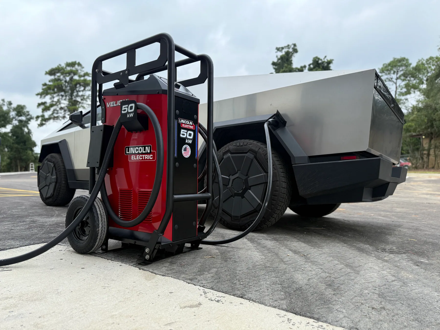 Lincoln Electric charging equipment beside a fleet vehicle
